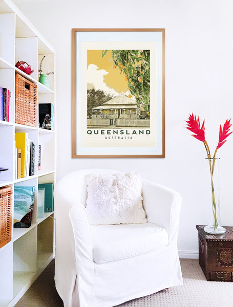 Queenslander house with mango tree poster print in wooden frame with armchair